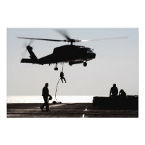 Personnel fast-rope out of an SH-60F