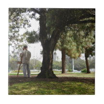 Photo of a man painting in the park tiles