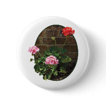 Pink and Red Geraniums Against Brick