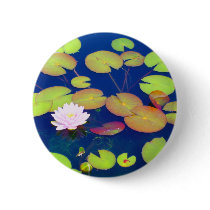 Pink Lotus Flower floating with lily pads on pond
