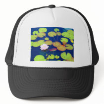 Pink Lotus Flower floating with lily pads on pond