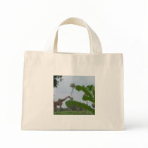 Plant and blue sky with giraffes in the background tote bag