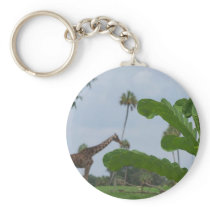 Plant and blue sky with giraffes in the background keychain