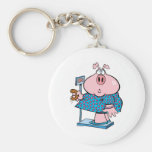 porc drôle à un régime mangeant un beignet sur une porte-clefs