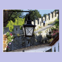 Portugal, Obidos. Iron streetlamp and 14th postcards