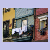 Portugal, Oporto (Porto). Woman hanging laundry postcards
