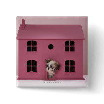 Puppy peering out of doll's house pinback button