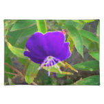 purple flower against green painted effect place mats