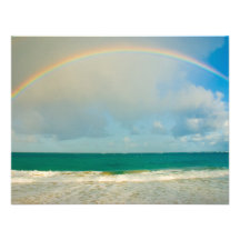 Rainbow over ocean invites
