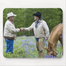 Ranchers shaking hands across the fencing in mousepads