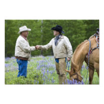 Ranchers shaking hands across the fencing in