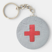 Red cross on grey flaking paint nyckel ring