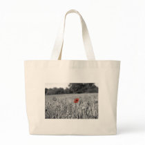 red poppy in a black and white field bag