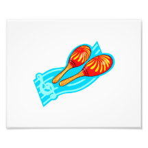 Red yellow maracas with blue staff behind photograph