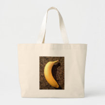 Ripe yellow banana on granite tote bags