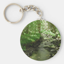 River flowing through woodland. keychains