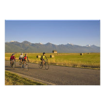 Road bicyclists ride down a back country road photo