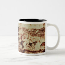 Rock painting of a leaping cow mugs