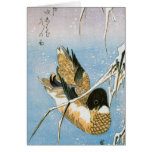 Roseaux chargés par neige de natation de canard sa carte de vœux