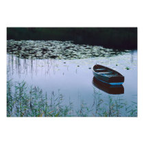 Rowboat on small lake surrounded by water