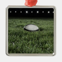 Rugby ball sitting on the grass pitch of a christmas ornament