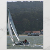 Sailboat in harbour against green mountain flyers