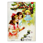 Salutation de Noël avec des filles regardant le Ch Carte