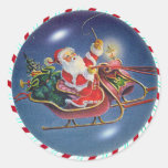 SANTA, SLEIGH & CANDY CANE WREATH by SHARON SHARPE Round Stickers