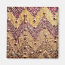 Section of embroidered fabric with gold plaques refrigerator magnet