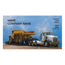 semi truck and trailer hauling a large dumptruck business card