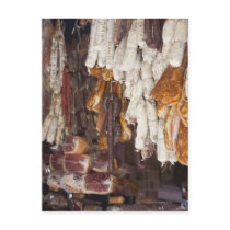 shop displaying an assortment of sausages and postcard