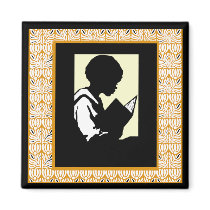 Silhouette of boy reading refrigerator magnet