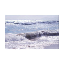 Silver waves breaking on the beach canvas prints