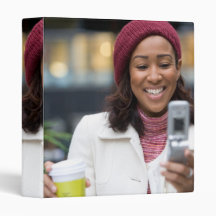 Smiling Business Woman with Cell Phone Binders