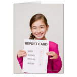 Smiling girl student proud of report card
