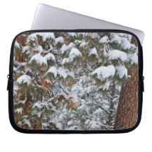 Snow fills the boughs of ponderosa pine trees computer sleeves