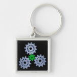 Some silver gears with a little green keychains