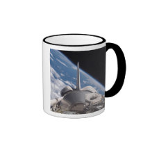 Space Shuttle Discovery backdropped by Earth Coffee Mugs