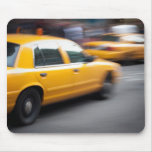 Speeding Yellow NY City Taxi Cab with Motion Blur mousepads