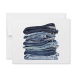 Stack of blue jeans invites