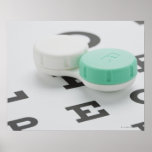 Studio shot of contact lens case on eye chart poster