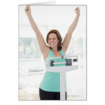 Successful weight loss. Happy woman weighing Greeting Cards