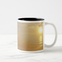 Sun sets over the Pacific Ocean from Heceta Coffee Mug