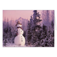 Sunset Snowman in the Winter Mountains Greeting Cards
