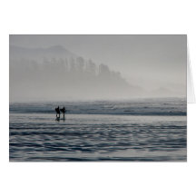 Surfers in the mist. greeting card