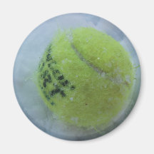 Tennis ball in the snow refrigerator magnet