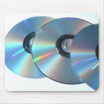 Three Cds On A Paper Mouse Pads