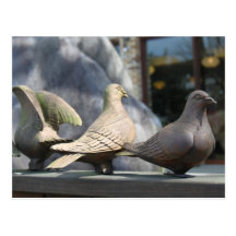 Three wooden pigeons postcard