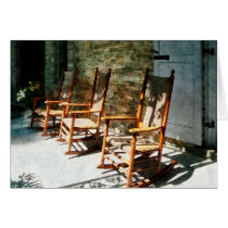 Three Wooden Rocking Chairs on Sunny Porch