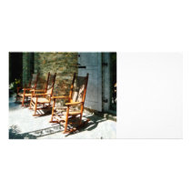 Three Wooden Rocking Chairs on Sunny Porch